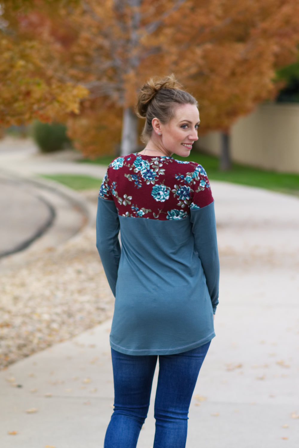 Back view of a tunic-length Nicolette featuring a crew neck, color blocking, and long sleeves. 