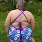 Back view of the Annette swimsuit. The pattern is a colorful floral design. Features cross-x, adjustable back straps. 