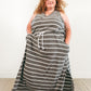 The Helen dress in plus size. Features a crossover racerback bodice, maxi-length skirt with a split hem, and pockets. 