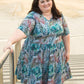 Emmeline in plus size featuring elbow-length sleeves, v-neck, and knee-length skirt. 