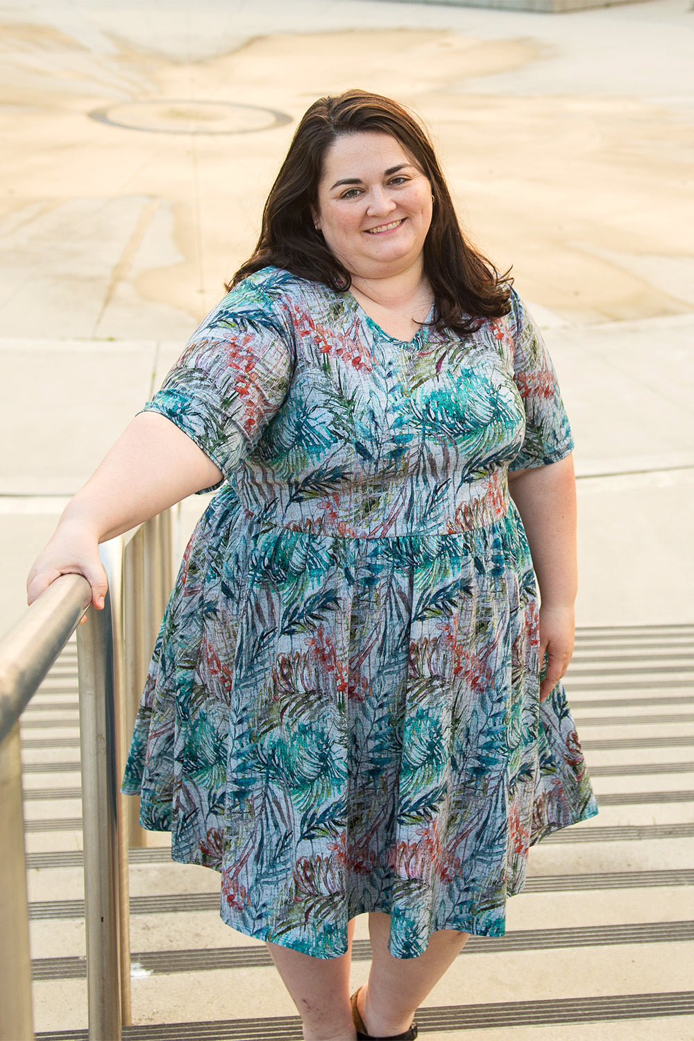 Emmeline in plus size featuring elbow-length sleeves, v-neck, and knee-length skirt. 