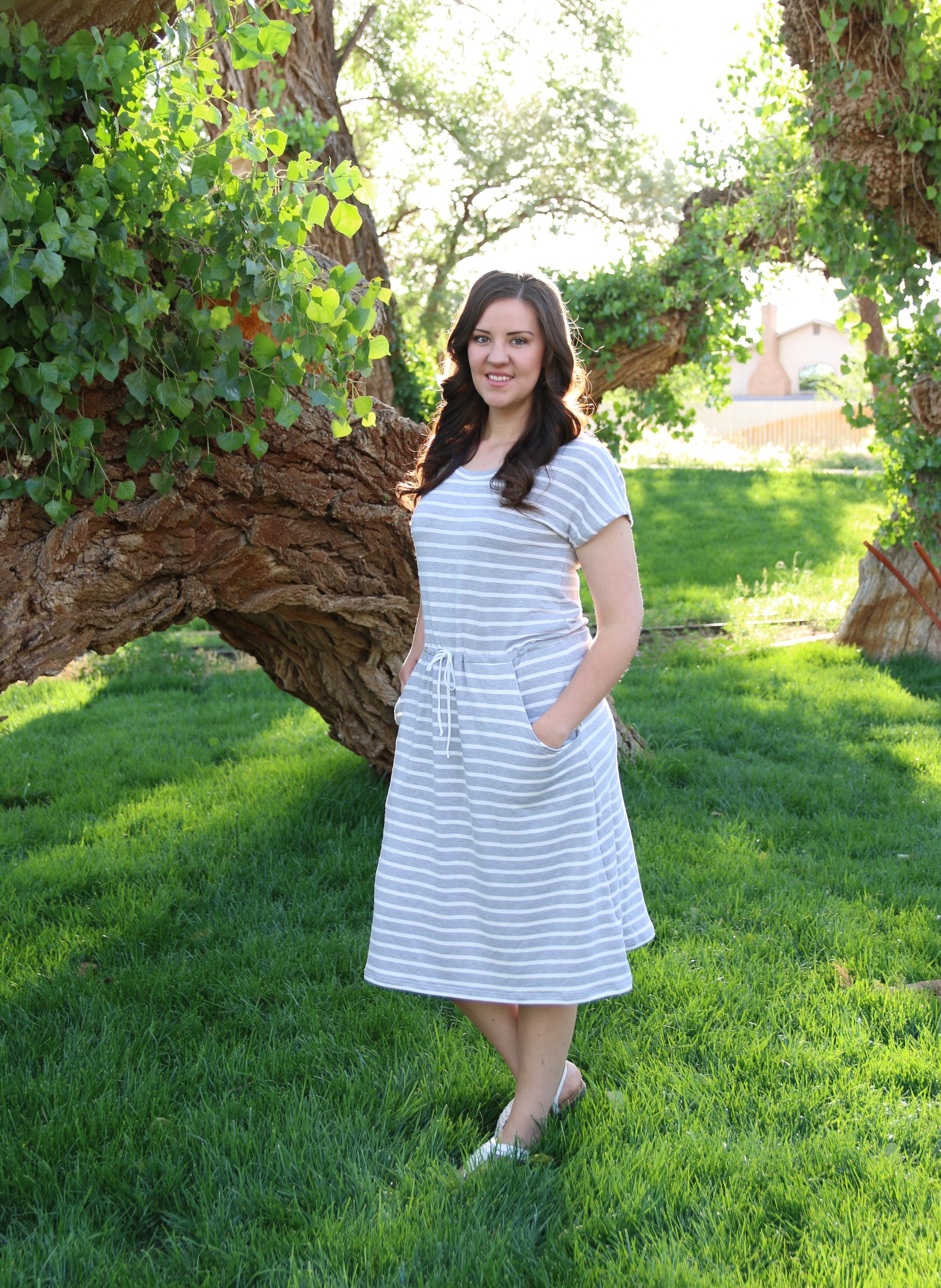 The Helen Dress in misses size. Features a solid front, knee-length skirt, and pockets. 