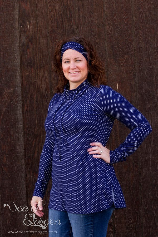 Front view of the Nora sweater with a drawstring funnel neck, long sleeves, and split hem. 