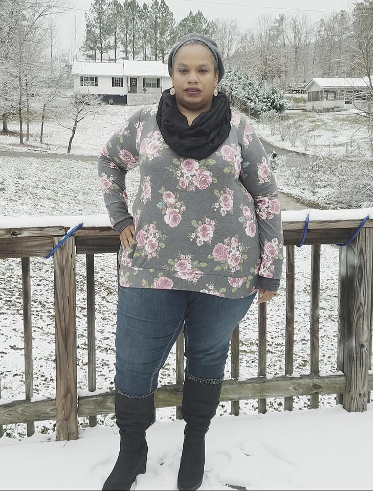 The Nora sweater with long sleeves and banded hem. Accented with a black scarf. Plus size. 
