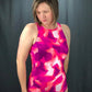 Front view of Amelia one-piece swimsuit made from a pink, purple, and white geometric fabric and high neck option.