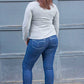 Back view of woman wearing Bravado jeans with decorative pocket stitching