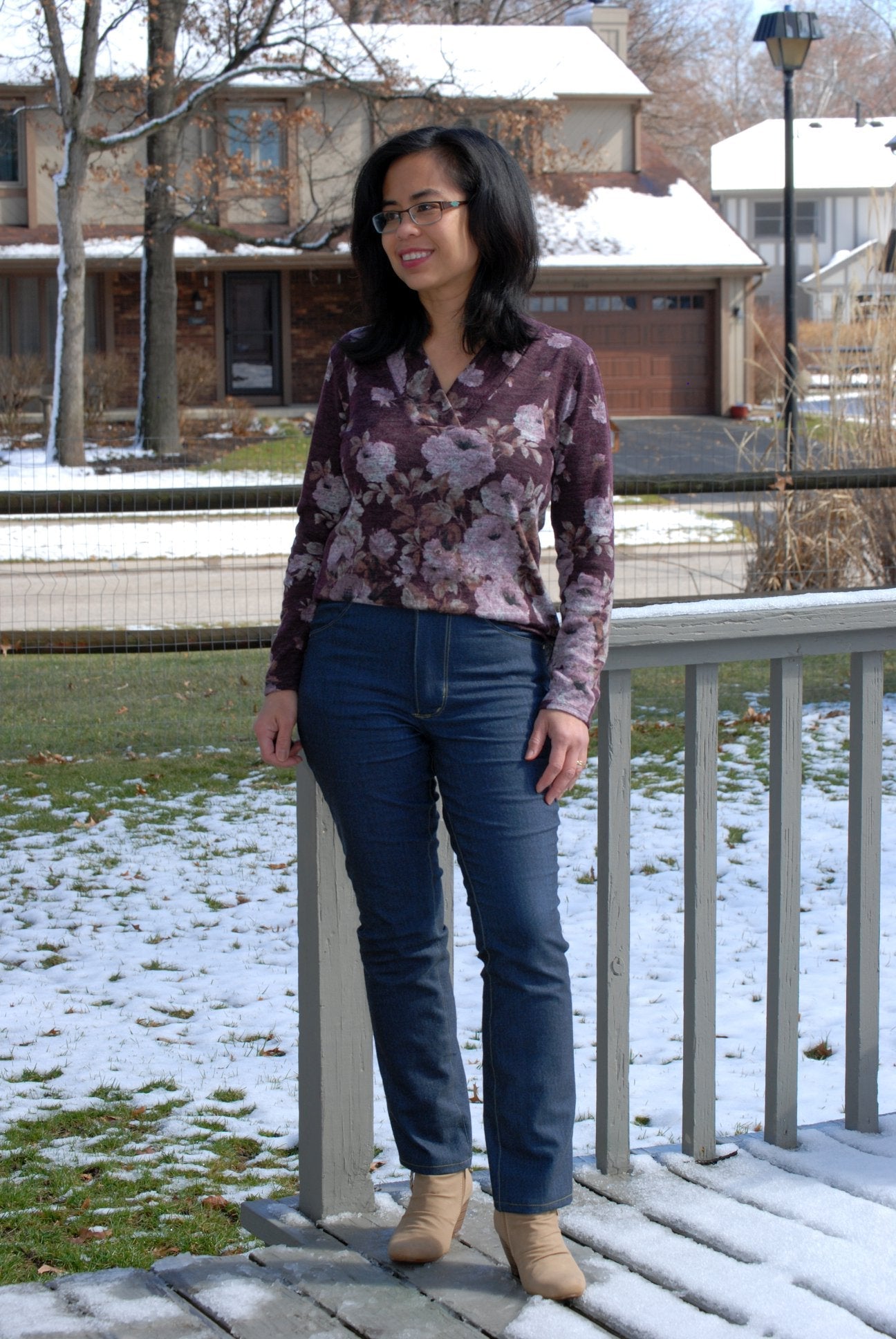 Front view of woman wearing Bravado jeans with topstitching and a pair of boots