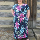 The Helen Dress in plus size. Features a solid front and maxi-length skirt. 