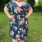 The Helen Dress in plus size. Features a crossover front and knee-length skirt. 