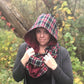 Hooded infinity pattern tester. Features a hood up with a plaid design and merlot-colored lining. 
