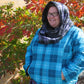 Hooded infinity scarf tester. Hood up. Features a black and white polka dot lining and a gray/black/white main color. 
