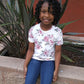 Young black girl in a rose pattern t-shirt