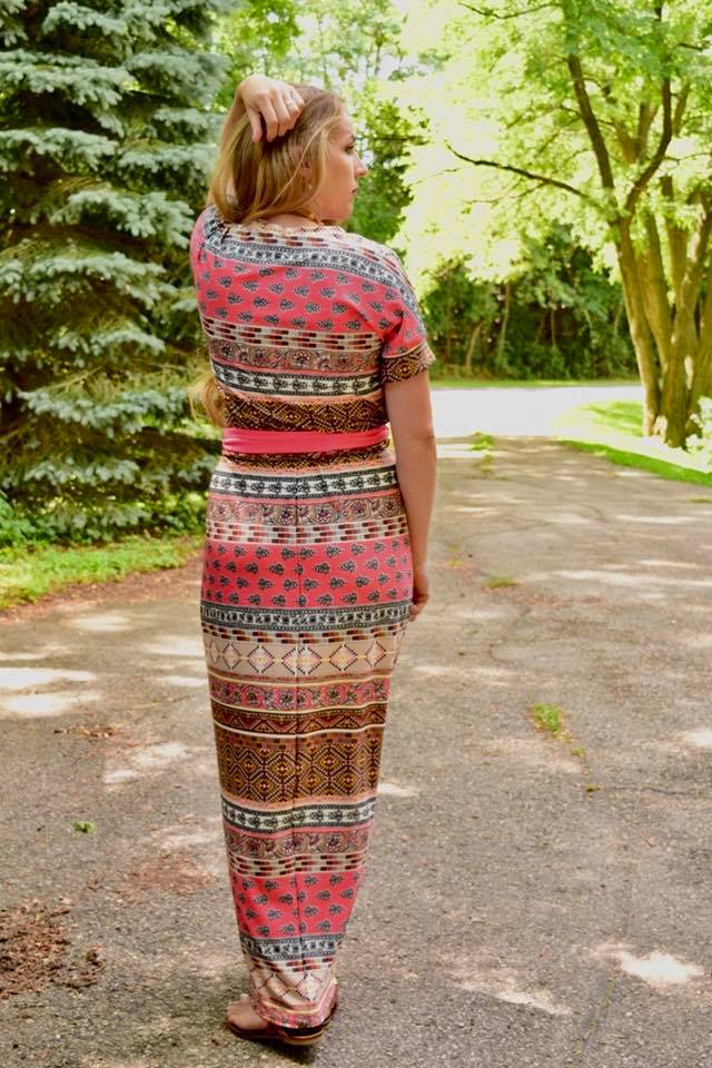 Back view of the Rosa. Features short sleeves and maxi-length skirt options. 