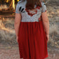 Back view of a young girl with a short sleeve, knee length Samantha dress. 