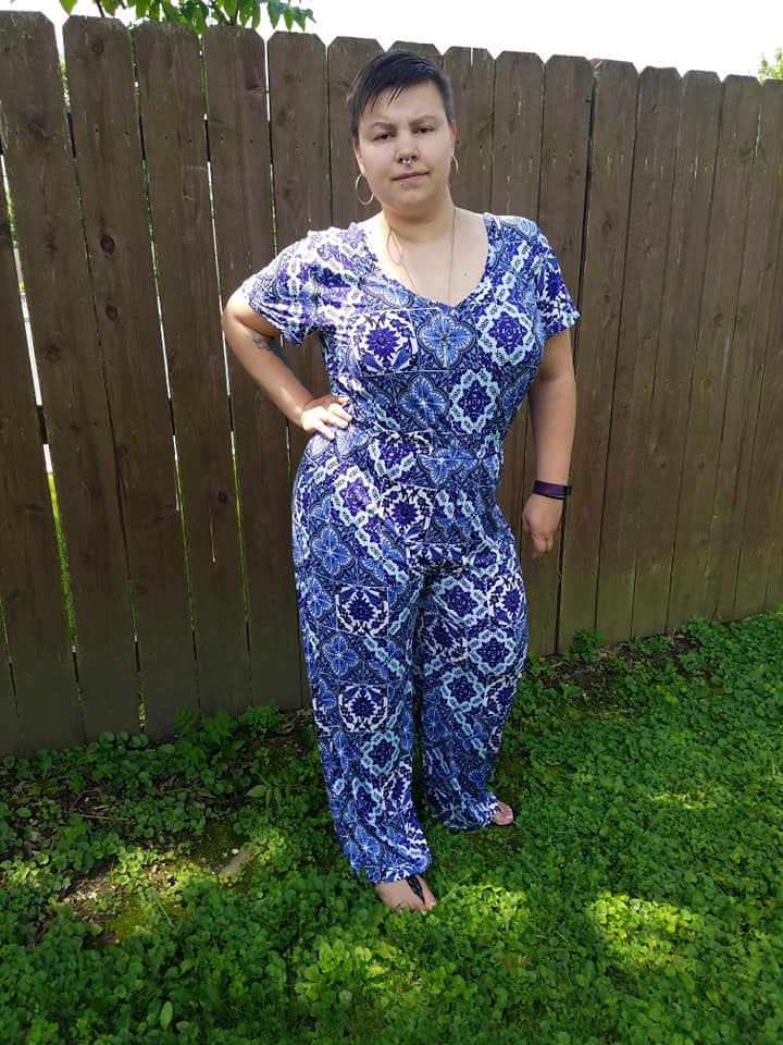 Front view of the Stevie romper in plus size. Features colorful blue pattern and short sleeves and wide leg pattern options. 